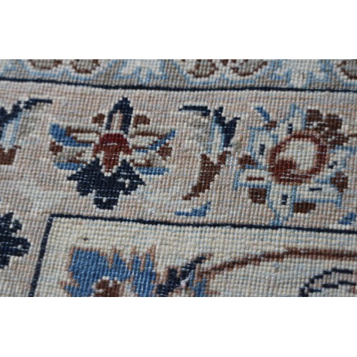 699 - A Persian Nain rug, finely woven with all-over floral design on a blue ground and multi-bordered in ... 