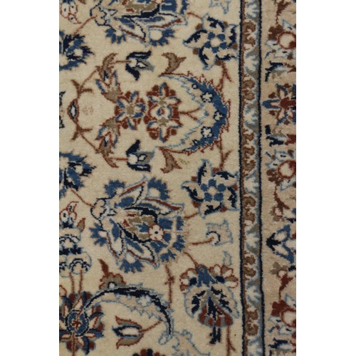 699 - A Persian Nain rug, finely woven with all-over floral design on a blue ground and multi-bordered in ... 