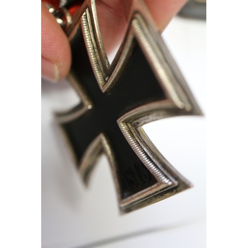 358 - A Knight's Cross of the Iron Cross medal, in case, a white cigarette case, stamped 900 and engraved ... 