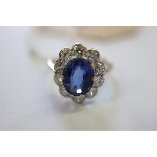 349 - An 18ct gold, platinum, diamond and blue stone cluster ring, size M/N, 3.2g