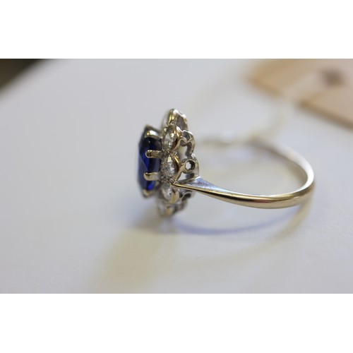 349 - An 18ct gold, platinum, diamond and blue stone cluster ring, size M/N, 3.2g