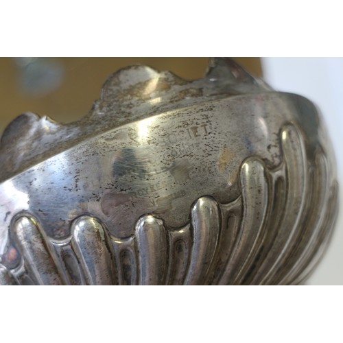 308 - A silver bowl with shaped rim and embossed decoration 6