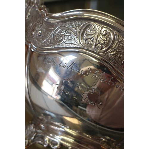 326 - A silver rosebowl with engraved border and scrolled feet, 31.1oz troy approx