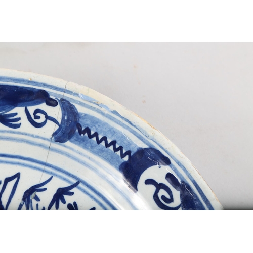 35 - An early 18th century Dutch delft dish with vase and floral centre, 13 1/2