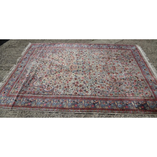 749 - A Persian part silk pile rug with an all-over scroll floral design in shades of blue, red, green and... 