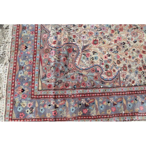 749 - A Persian part silk pile rug with an all-over scroll floral design in shades of blue, red, green and... 