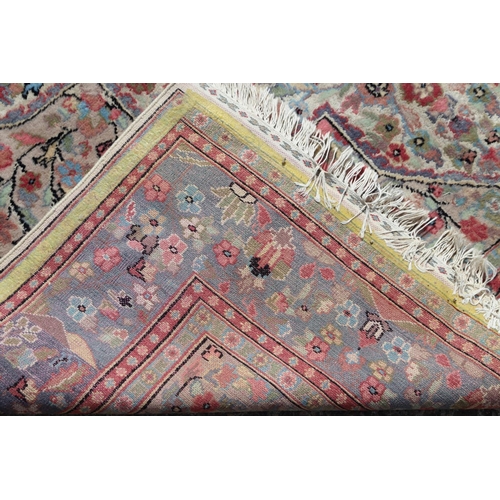 749 - A Persian part silk pile rug with an all-over scroll floral design in shades of blue, red, green and... 