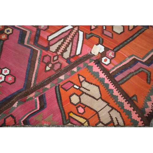 743 - A kelim rug of traditional geometric design with star medallion on an orange ground, 95