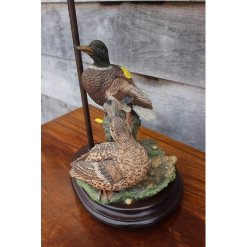 235 - A modern table lamp, formed as mallard ducks, on oval base, 26