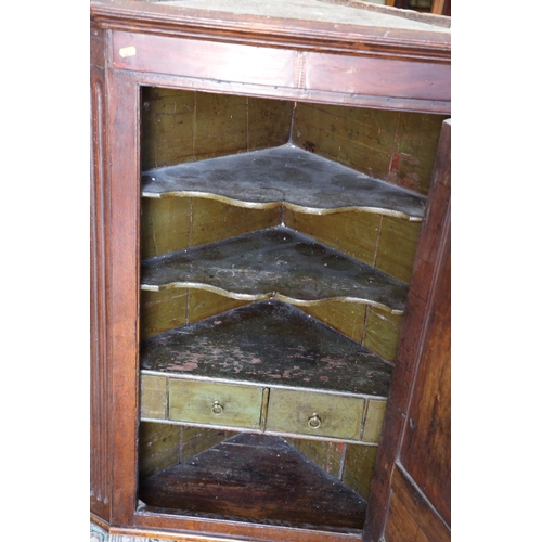 525 - A Georgian oak and shell paterae inlaid corner hanging cupboard, the interior with original paint, f... 