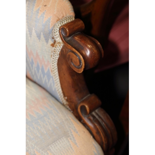 539 - A 19th century mahogany showframe armchair, upholstered in a Florentine fabric, on turned supports