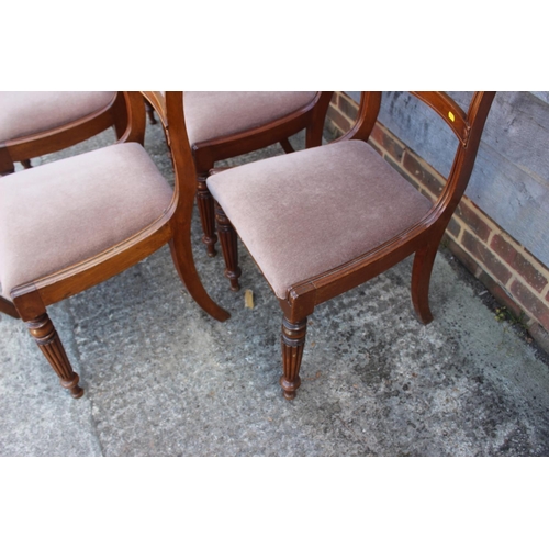 543 - A set of six Regency style mahogany bar back dining chairs with drop-in seats, upholstered in a ligh... 