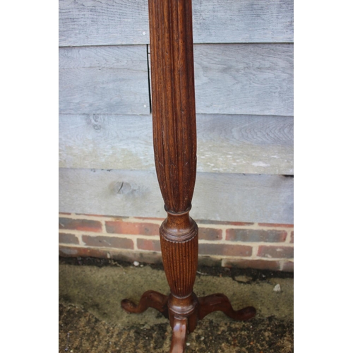 241 - An early 20th century turned and fluted mahogany standard lamp