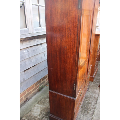 533 - A Georgian figured mahogany and satinwood banded bookcase enclosed two doors over two short and one ... 