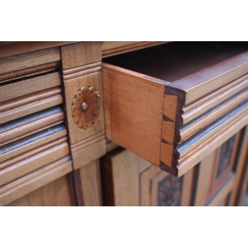 545 - A 19th century walnut and ebonised bookcase with glazed upper section enclosed two doors over two dr... 