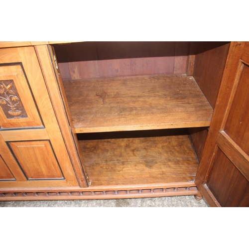 545 - A 19th century walnut and ebonised bookcase with glazed upper section enclosed two doors over two dr... 