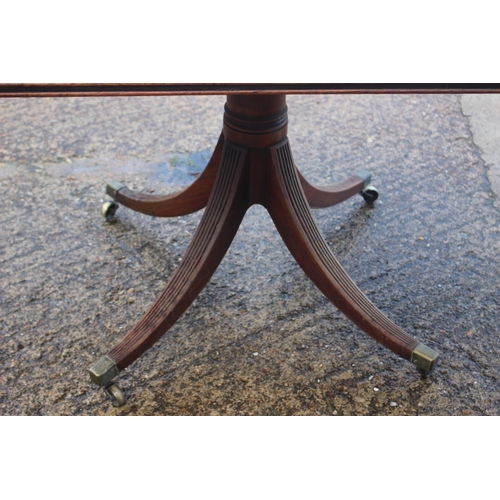 552 - An early 19th century mahogany rectangular tilt top breakfast table, on turned column and quadruple ... 