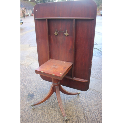 552 - An early 19th century mahogany rectangular tilt top breakfast table, on turned column and quadruple ... 