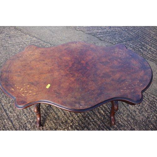 554 - A late 19th century walnut and inlaid shape top centre table, on turned and stretchered supports and... 