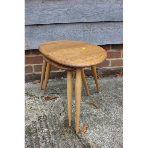 569 - Two Ercol light elm pebble tables, larger: 19 1/2