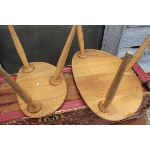 569 - Two Ercol light elm pebble tables, larger: 19 1/2