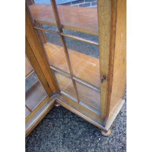 594 - A 1930s oak corner 'L' shaped bookcase/display cabinet enclosed lattice glazed doors, 28