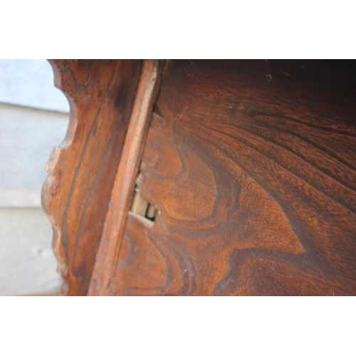 610 - A Chinese carved elm side table, fitted two drawers, on turned supports, 39