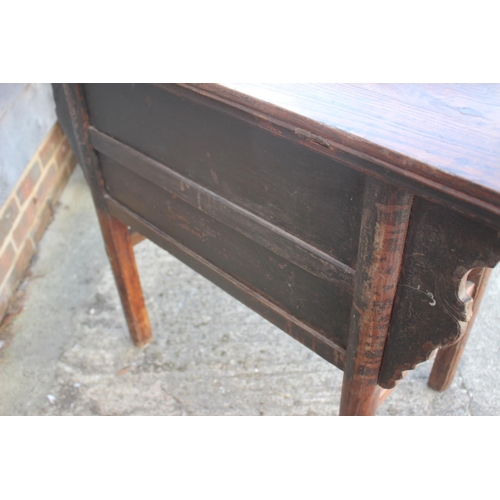 610 - A Chinese carved elm side table, fitted two drawers, on turned supports, 39