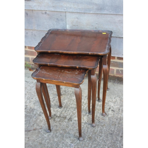 613 - A mahogany two-tier lamp table, fitted one drawer, on turned and castored supports, 18