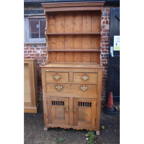 662 - A Continental pine dresser, fitted shelves over three drawers and cupboard enclosed spindle panel do... 