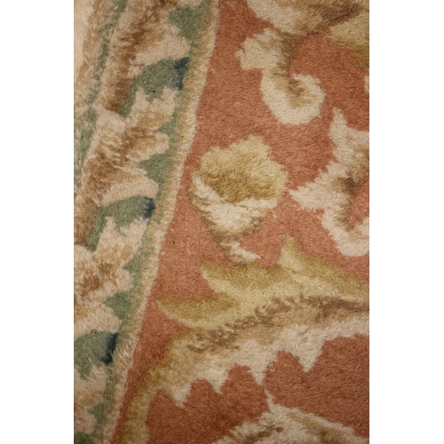 666 - An Indian wool contour pile carpet of Aubusson design, on a cream ground, 141