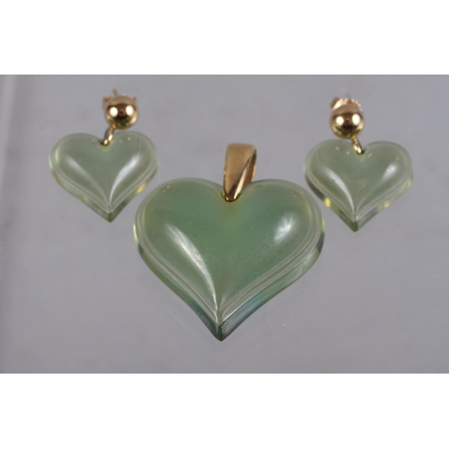 317 - A pair of Lalique green glass heart-shaped earrings and a matching pendant