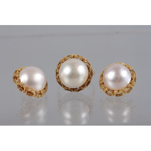 320 - A Continental yellow metal and pearl dress ring, size Q, 8.5g, and a matching pair of earrings, 11.6... 