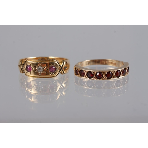 381 - A 9ct gold garnet set half eternity hoop, 2g gross, size L 1/2, an 18ct gold ring set two rubies and... 