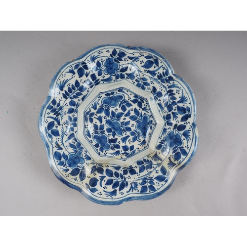 16 - An 18th century majolica lobed dish with floral decoration, 10 1/4