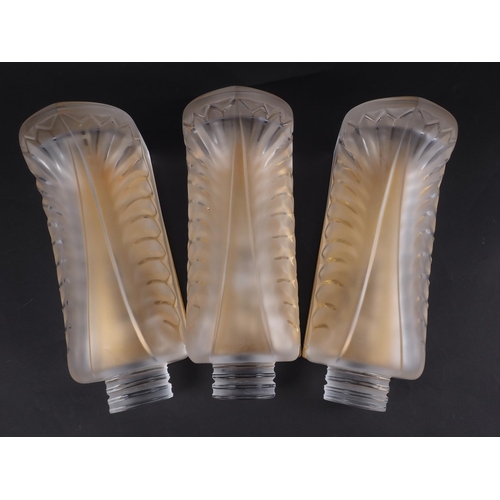 242 - A set of three Lalique cast glass Palme wall sconces with gilt metal back plates, 10 1/2