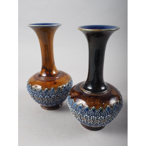 25 - A pair of Doulton Burslem bulbous vases with relief decoration, 7 3/4