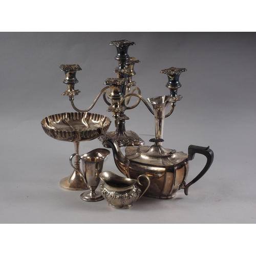 257 - A silver plated candelabra, a shaped teapot, a cream helmet, a milk jug, a tazza and a flower vase, ... 