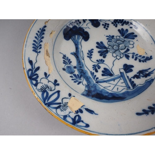 29 - An 18th century English Delft polychrome plate with fence design, 9