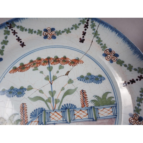 29 - An 18th century English Delft polychrome plate with fence design, 9