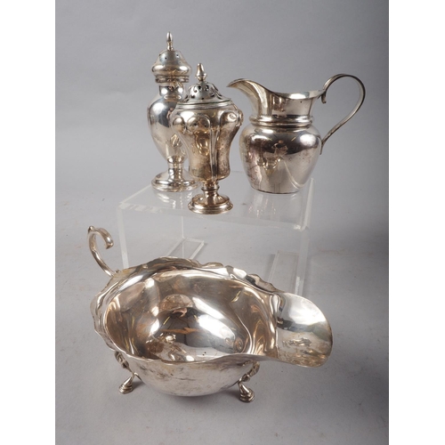 292 - A silver sauce boat, a pepperette, a cream jug and a pepperette with weighted base, 6.9oz troy appro... 