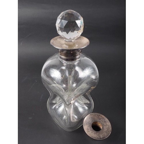 293 - A silver topped tapered decanter with a spare silver top