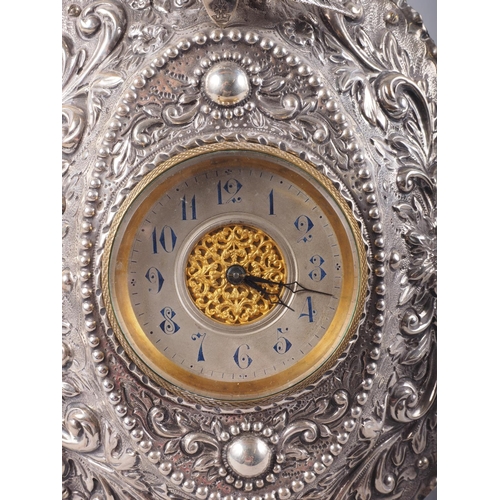 296 - An embossed easel clock with bird and scroll decoration, 7 1/4