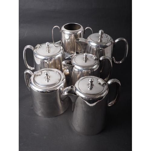 302 - An assortment of silver plate, including two teapots, two coffee pots, one hot water pot and one sug... 