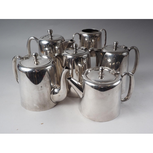 302 - An assortment of silver plate, including two teapots, two coffee pots, one hot water pot and one sug... 