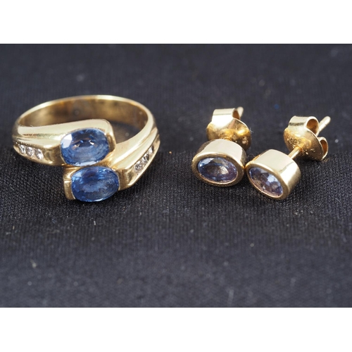 309 - A yellow metal, stamped 750, two Sri Lankan sapphires and diamond set crossover ring, size M, and a ... 