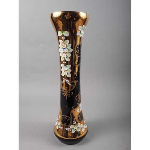 33 - A Bohemian blue glass, gilt and high relief floral decorated vase, 16