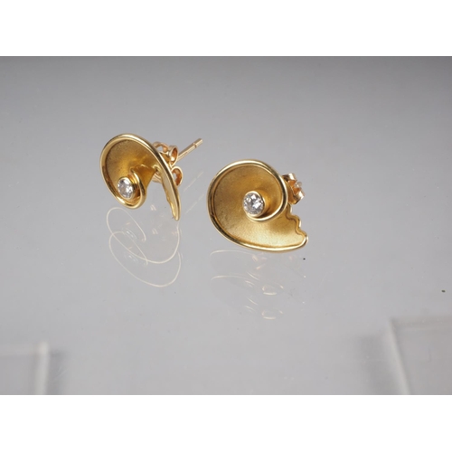 334 - A pair of 18ct gold spiral studs set diamonds, by Annabel Ely, 3.6g gross