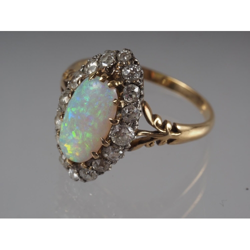 337 - An 18ct yellow gold dress ring, set oval opal with collar of diamonds, opal 13mm x 6mm approx, size ... 