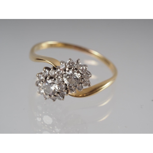 339 - An 18ct gold crossover cluster ring set twenty-two diamonds, total ring 1ct approx, size O 1/2, 3.7g... 